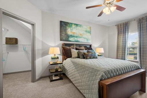 a bedroom with a bed and a ceiling fan at Stonepost Crossing Apartments, Overland Park, Kansas