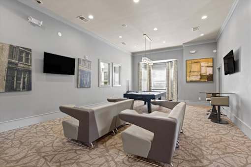 a living room with couches and a ping pong table at Stonepost Crossing Apartments, Overland Park, Kansas