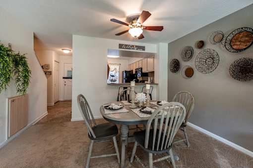 Dining table with breakfast bar looking into the kitchen at Fords Pointe Apartments