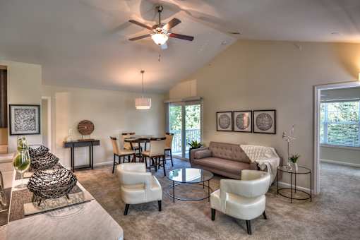 A living room with a ceiling fan and a couch.
