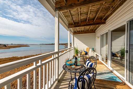 Private balcony with a table and chairs overlooking the Chesapeake Bay in Newport News, VA