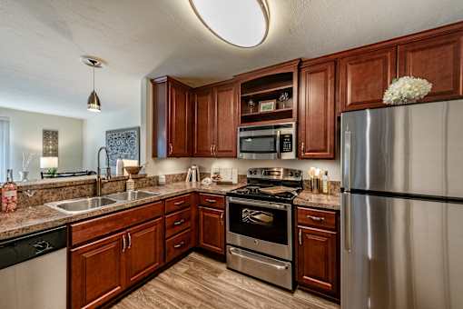 Kitchen with cherry cabinets and stainless steel appliances at Mill Creek Landing near Hampton VA