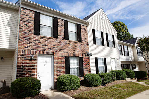 A row of houses with the first one having a white door.