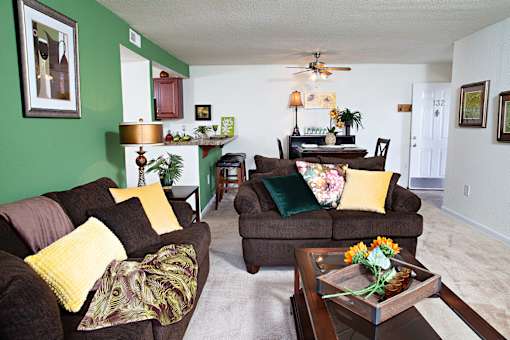 A living room with a brown couch and a coffee table.