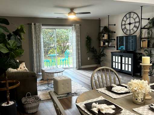 A dining room with a table set for a meal.