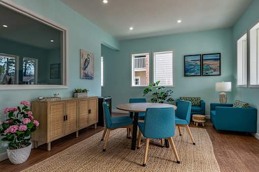 A dining room with a table set for four.