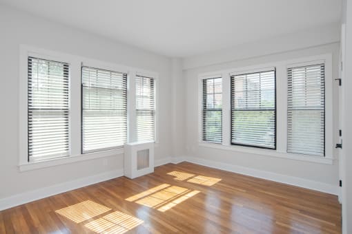 a living room with wood floors and windows