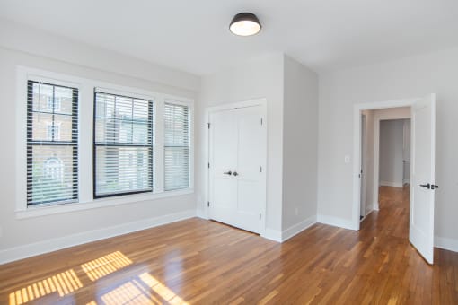 a living room with wood floors and a white door and window