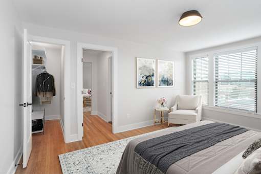 A bedroom with a large bed and a painting on the wall.