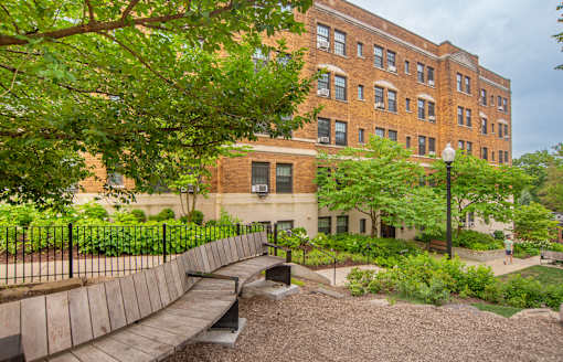 a wooden bridge in front of a brick building