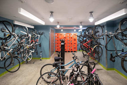 a room with many bikes on the wall and a wall of orange boxes