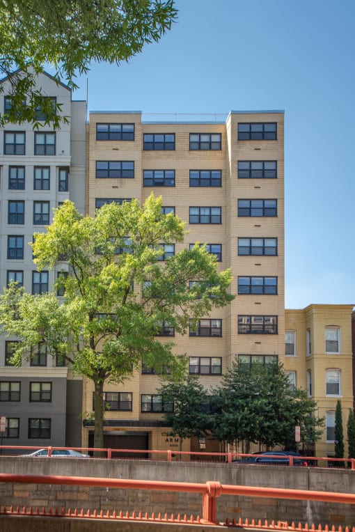a tall building with a tree in front of it
