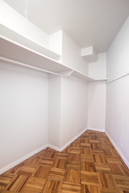 a white room with wooden floors and white walls