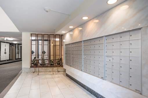 a long wall of lockers in a lobby of a building