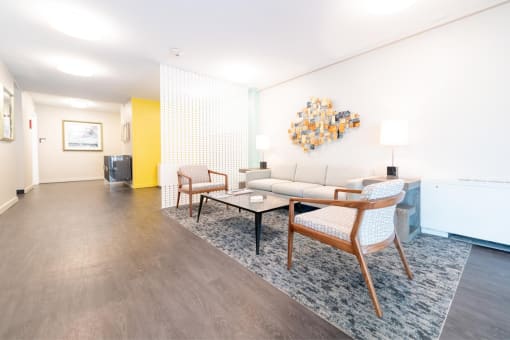 a living room with a couch and chairs and a table
