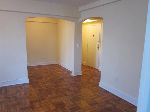 A room with a wooden floor and a door.
