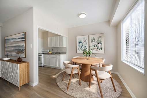 A dining room with a round table and chairs.