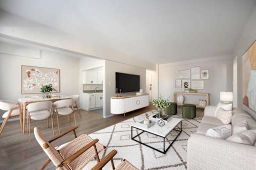 A modern living room with a white sofa, wooden chairs, and a coffee table.