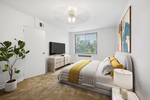 a bedroom with a bed and a tv