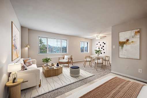 A living room with a white couch, a wooden coffee table, and a large painting on the wall.
