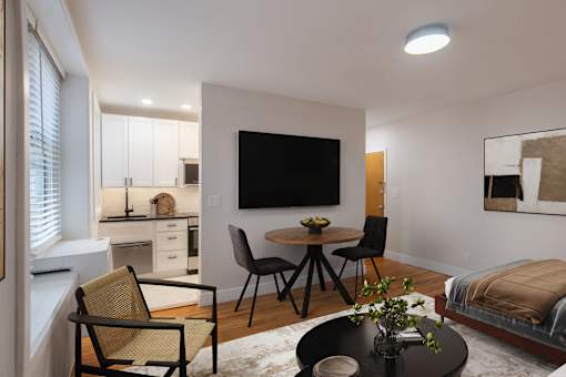 A modern living room with a television, a dining table, and chairs.