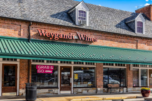 a brick building with a green roof and a sign that reads wings