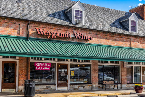 a brick building with a green roof and a sign that reads wines