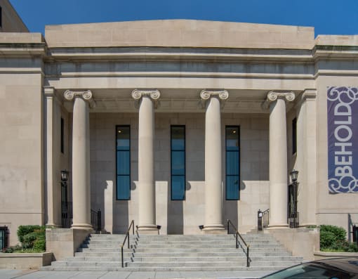 the front of a building with columns and stairs