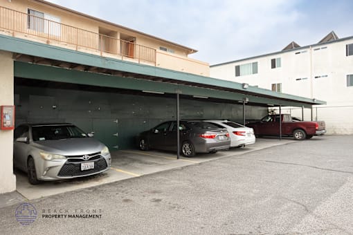 A parking garage with a Lexus and a Toyota parked in it.