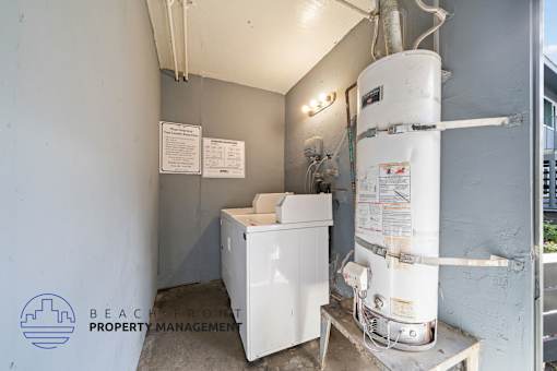 A room with a water heater and a washing machine.