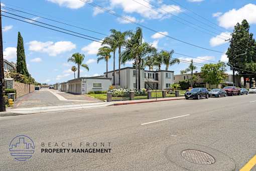 A street view with the logo of Beach Front Property Management.