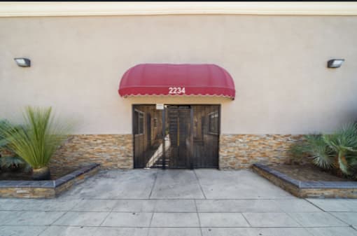 A building with a red awning and the number 2234 on it.