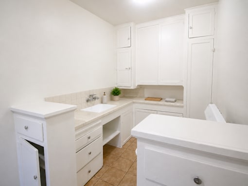 A white bathroom with a sink, toilet, and bathtub.