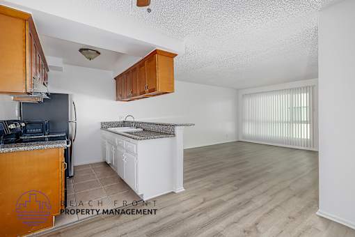 A kitchen with wooden cabinets and a white countertop.