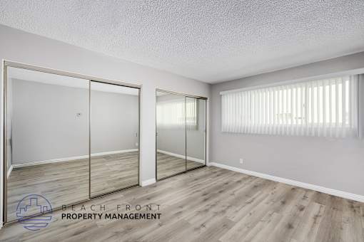 A room with a sliding door and wooden flooring.