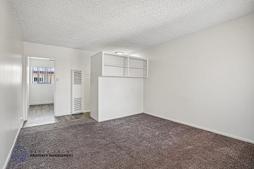 A room with a carpeted floor and white walls.