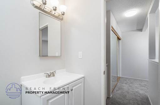 a bathroom with a sink and a mirror and a shower