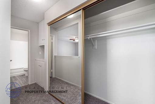 a mirror in a bathroom with a closet