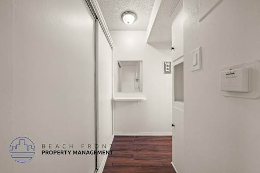 A hallway with a logo for Beach Front Property Management.
