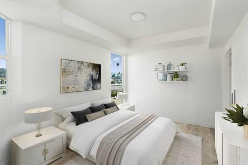 A bedroom with a large bed and a painting on the wall.