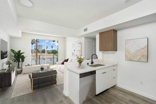 A modern kitchen with a large window overlooking a cityscape.