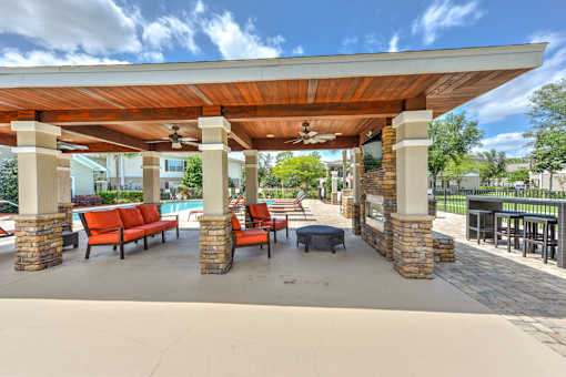 A covered patio area with a pool table and seating.