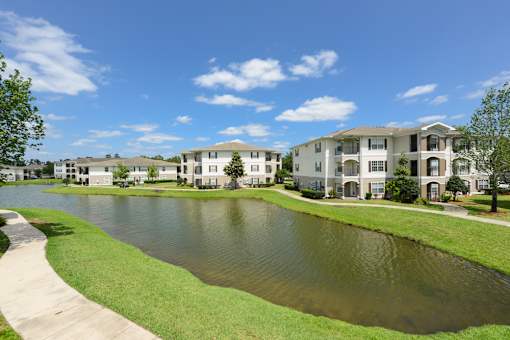 A large body of water in front of apartment buildings.