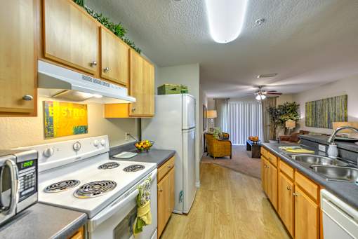 A kitchen with wooden cabinets and a stove top oven.