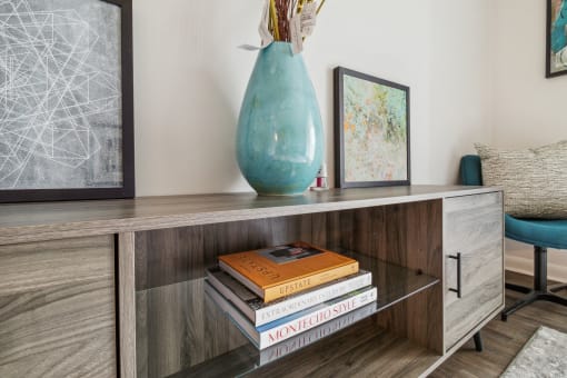 a console table with a vase and books on it