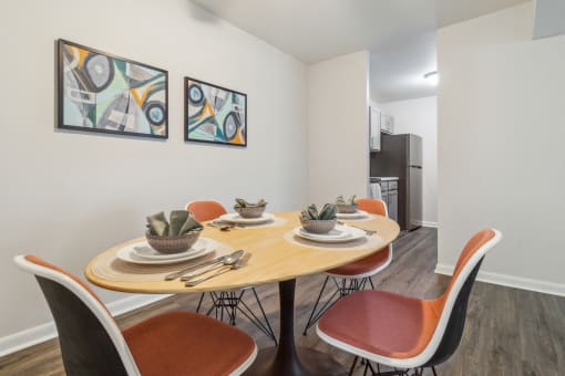 a dining room with a table and chairs and a kitchen