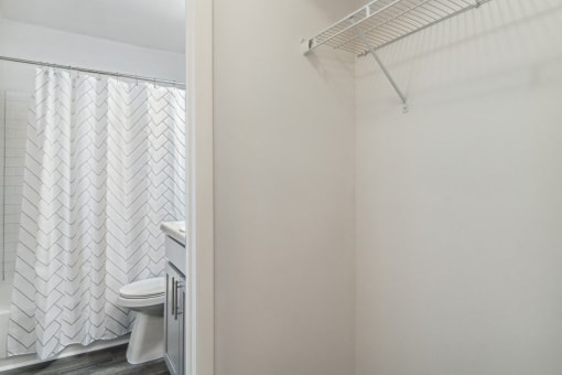 a bathroom with a shower and a toilet and a shower curtain
