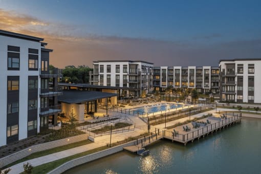 an aerial view of a resort with a pool and a dock