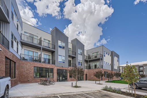 a picture of an apartment complex with a blue sky in the background
