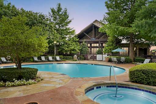 a swimming pool with a hotel in the background